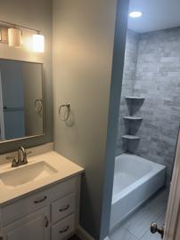 Bathroom with tub and tiled surround