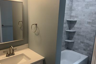 Bathroom with tub and tiled surround